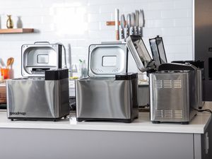 An assortment of bread makers displayed on a white countertop