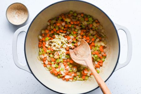 add garlic to the vegetables in the pan 