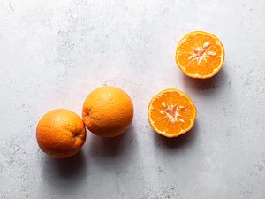 Bitter oranges, some whole some cut in half