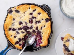 Blackberry cobbler served with whipped cream