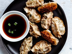 Chinese pan-fried dumplings with dipping sauce