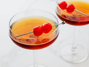 Classic Manhattan cocktail with whiskey and garnished with cherries