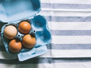 Brown eggs on striped tablecloth
