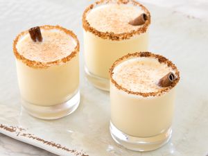 Fireball Eggnog cocktail in three glasses garnished with cinnamon