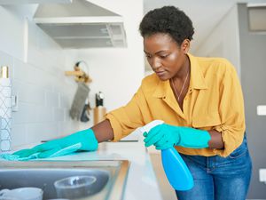 black woman cleaning kitchen