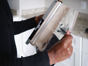 person removing aluminum foil from roll