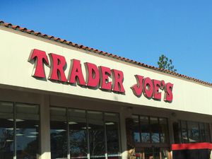 A Trader Joe's storefront with a blue sky
