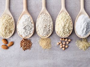 variety of gluten free low carb flours in wooden spoons
