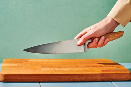 Someone holding a chef's knife with the blade grip