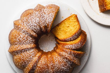 Kentucky butter bundt cake sliced and sprinkled with confectioners' sugar
