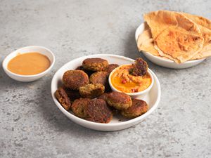 Quick and easy falafel recipe on a plate with pita and hummus