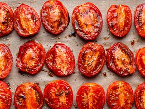 roasted tomatoes on a lined baking sheet