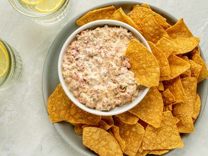 Sausage Dip in a bowl, served with a side of chips 