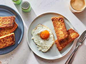 fried scrapple served with sunny side up eggs on a plate