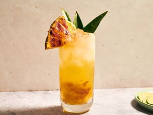 A grilled pineapple chartreuse swizzle cocktail