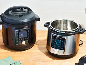 Two instant pots displayed on a wooden counter