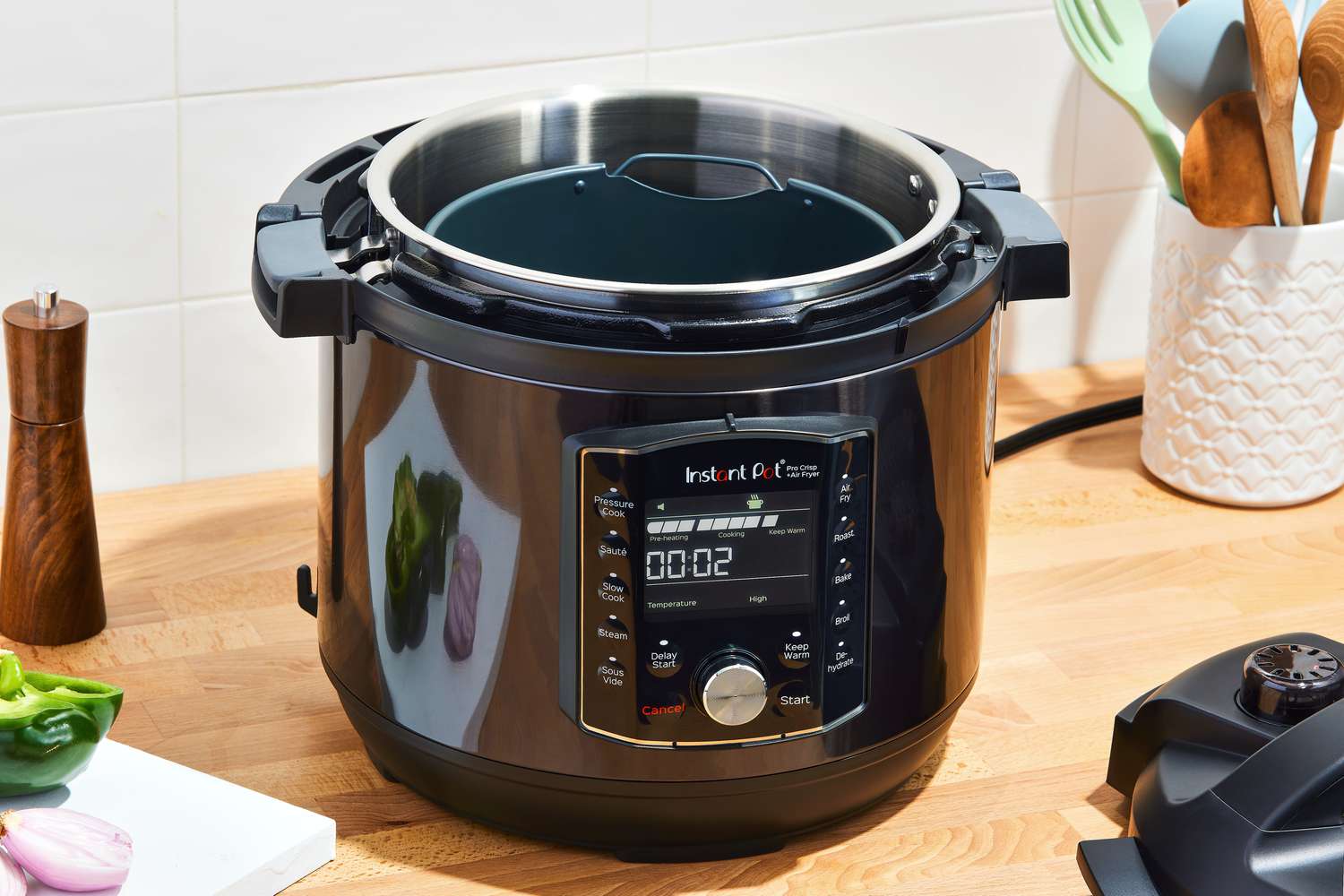 Instant Pot Pro Crisp & Air Fryer 8-Quart Multi-Use Pressure Cooker and Air Fryer displayed on a wooden countertop next to a utensil stand