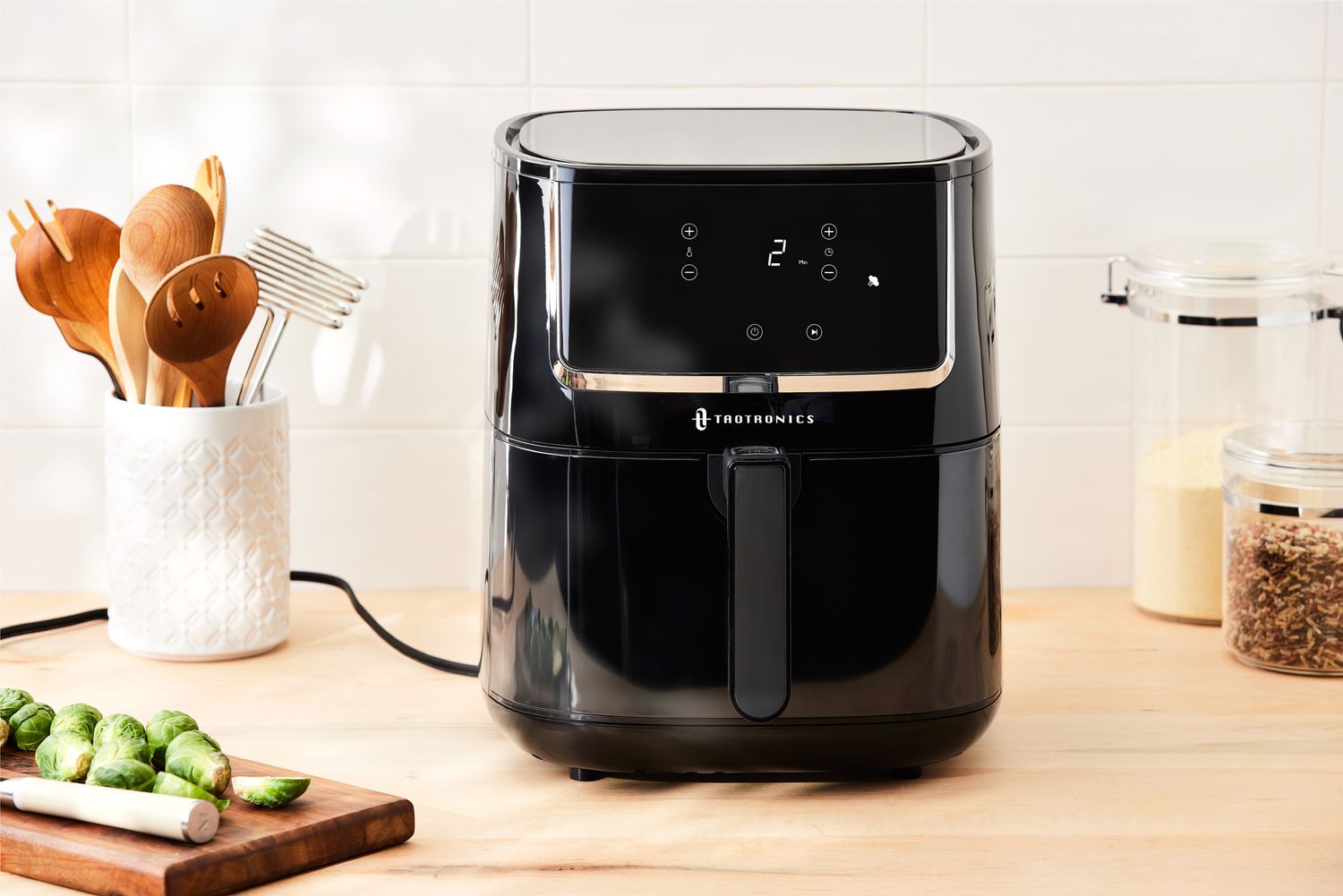 TaoTronics Air Fryer TT-AF001 displayed on a wood counter with a white tile background