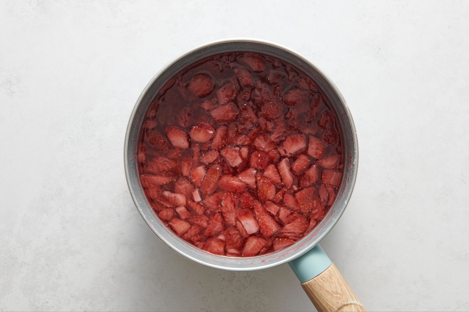 A pot of strawberry syrup