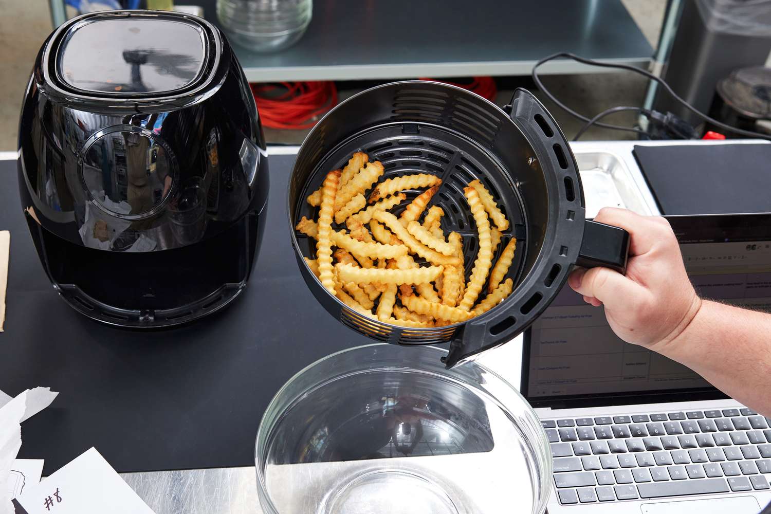 Hand holding a basket of fries from the Chefman TurboFry 3.7-Quart Air Fryer