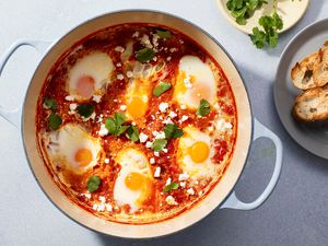 Shakshuka in a pot, served with toasted bread 