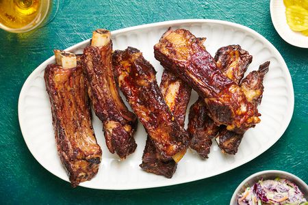 Tender Slow-Grilled Beef Ribs on a white platter 