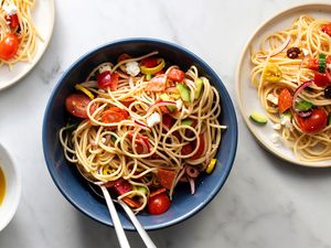 Spaghetti salad in a bowl and on plates 