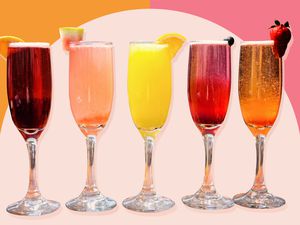 Five champagne glasses filled with various brunch drinks 