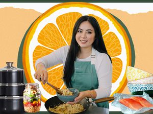 Woman in front of a large orange with cooking gear surrounding her