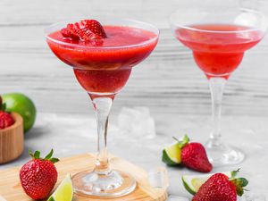 Frozen strawberry daiquiri with fresh strawberries and limes