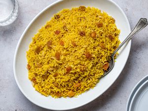 Turmeric Rice in a platter with a serving spoon 