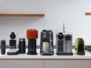 A variety of Nespresso machines side by side on a kitchen countertop