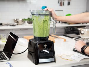 The Vitamix 2300 blending produce in the testing lab