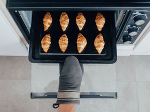 Taking croissants out of the oven